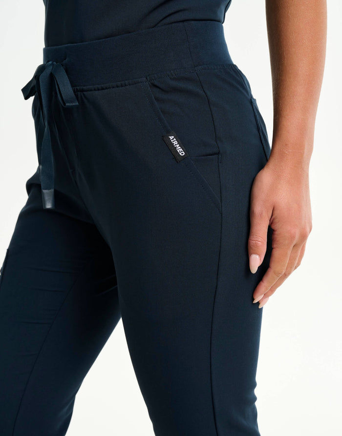 close up of hip pocket of midnight navy flare scrub pants