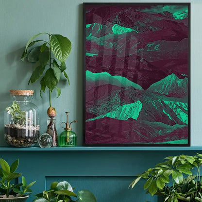 Abstract Mountains 1 print with bold green and purple hues in a black frame, displayed on a teal shelf.