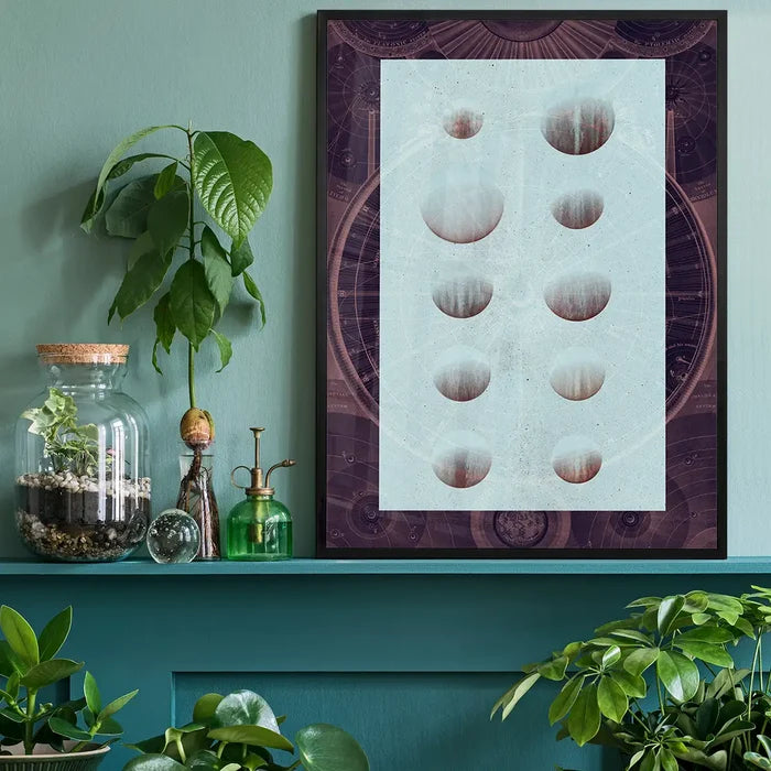Dark astrology chart print with vintage space diagram style and light blue abstract circles on a green wall.