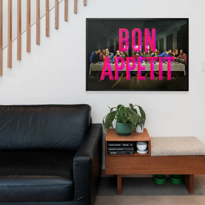 Black framed "Bon Appetit" typography print in neon pink over a Last Supper parody.