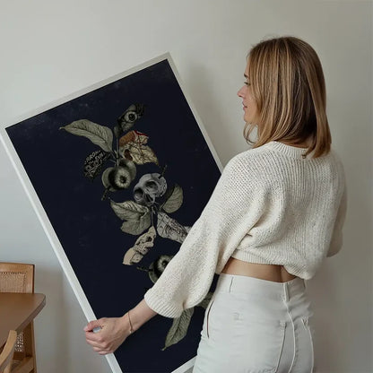 Woman holding a large Botanical Skulls Navy Print on archival art paper, featuring dark botanical elements and skulls.