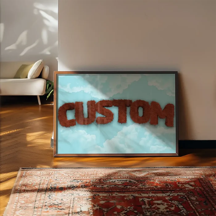 Brown fur-style "CUSTOM" text on a blue sky with clouds, framed art print on a wooden floor.