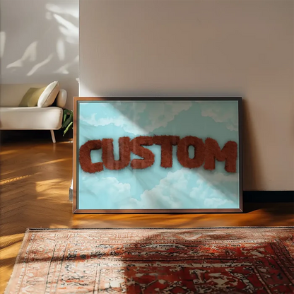 Brown fur-style "CUSTOM" text on a blue sky with clouds, framed art print on a wooden floor.