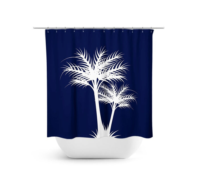 The image is of a shower curtain with two palm tree silhouettes in white against a navy blue background. The shower curtain is hanging on a shower rod above a white bathtub.