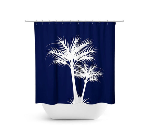 The image is of a shower curtain with two palm tree silhouettes in white against a navy blue background. The shower curtain is hanging on a shower rod above a white bathtub.