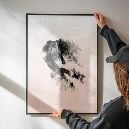 Abstract female form in dancing pose with cloud formations on pastel pink background, framed.