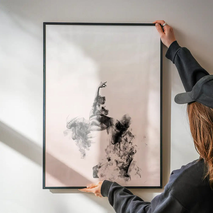 Abstract female dancer in cloud formations on pastel pink background, held by hands.