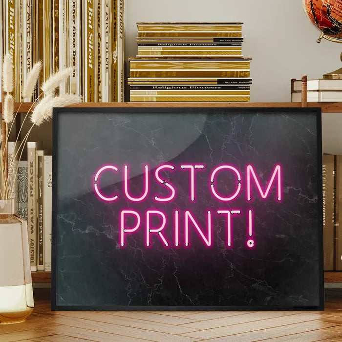 Pink neon "CUSTOM PRINT!" text on a black marble background in a sleek black frame.
