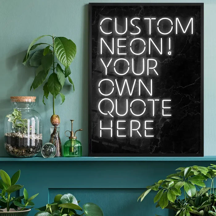 White custom neon quote print on black marble background, framed, displayed on a teal shelf with plants.