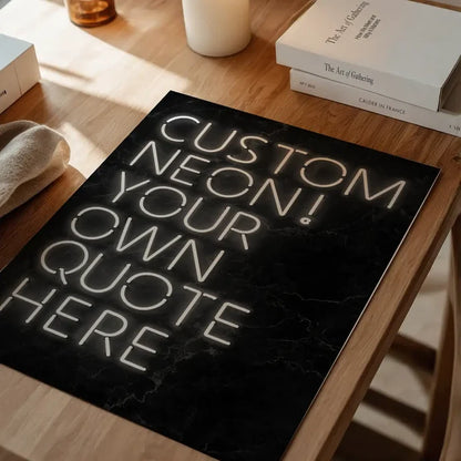Custom quote neon style poster print on a black marble background, displayed on a wooden table.
