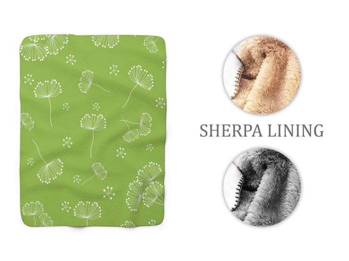 whimsical light green blanket with white dandelions scattered across