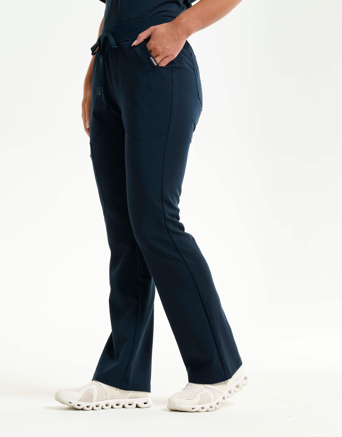 right with hip pocket of midnight navy flare scrub pants