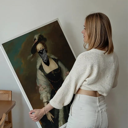Woman holding a framed "Gang Portrait Female Print" showing a vintage painting with a black bandana mask.