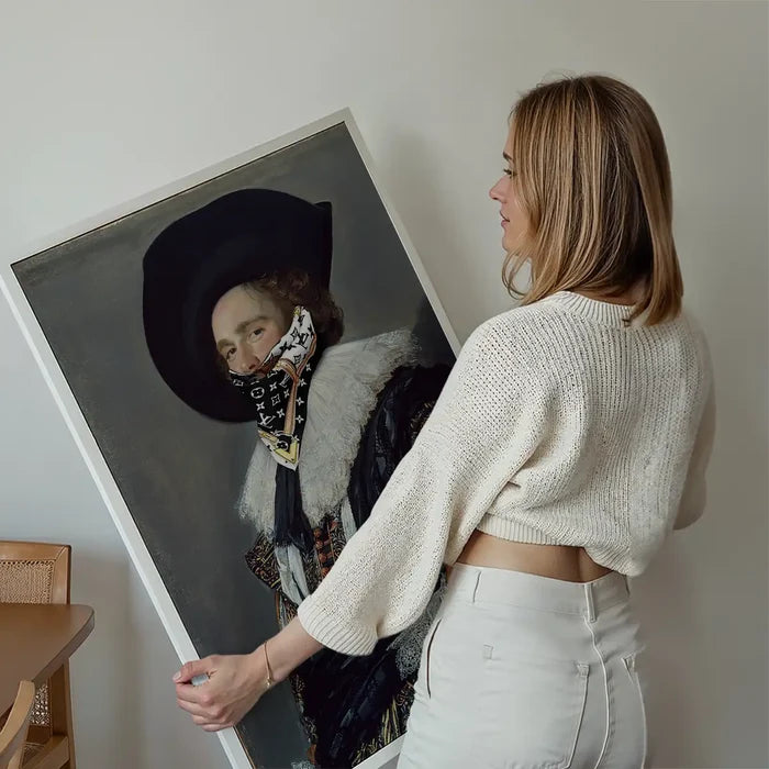 Woman holding a framed art print of The Laughing Cavalier wearing a Louis Vuitton scarf as a mask.
