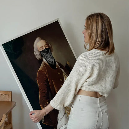 Woman holding a large print of a vintage portrait painting with a black gang mask over the face.
