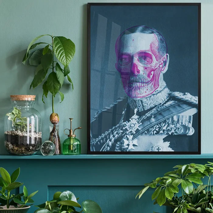 King George V portrait with a vibrant pink skull overlay, framed on a teal shelf.