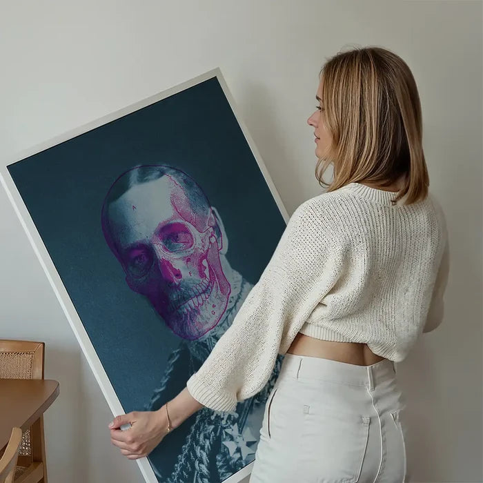 Woman holding a King George V skull colour print on dark paper with vibrant pink and purple tones.