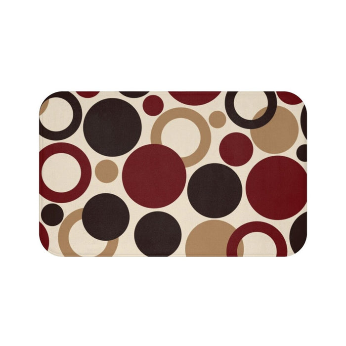 A rectangular memory foam mat with a brown and red geometric dots pattern and anti-slip backing.