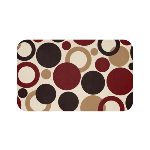 A rectangular memory foam mat with a brown and red geometric dots pattern and anti-slip backing.