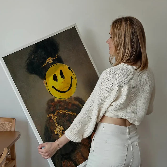 Woman holding a framed "Nobleman Smiley" print: classic painting with a yellow acid smiley face.