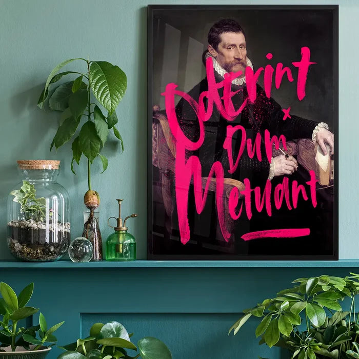 Black framed art print with neon pink "Oderint Dum Metuant" graffiti over a classic portrait.