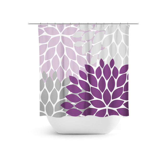 A shower curtain featuring a modern design with purple and gray flower burst pattern.
