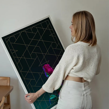 Woman holding a striking rose print with gold geometric lines on dark archival art paper.