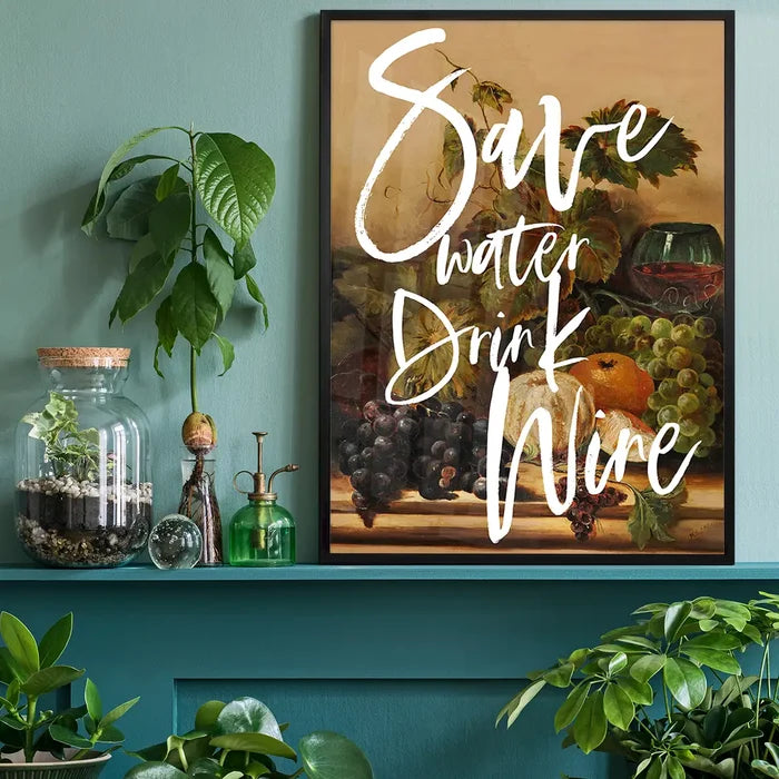 Framed "Save Water Drink Wine" art print with a still life of grapes, fruit, and wine glass on a teal shelf.