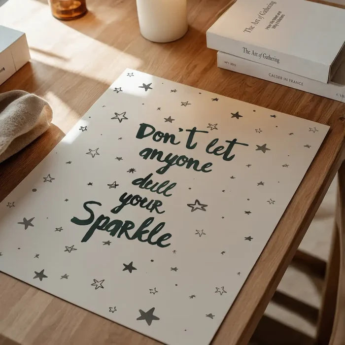 White typography print with "Don't let anyone dull your Sparkle" in dark green, surrounded by stars.