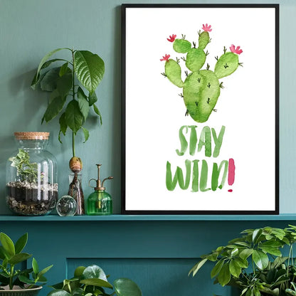 Watercolour "Stay Wild" quote print with a green cactus and pink flowers in a black frame.