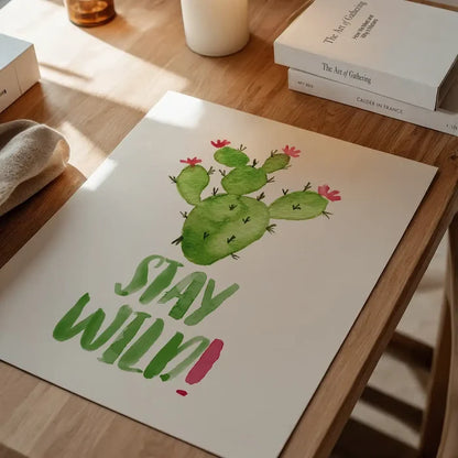 White print with green watercolor cactus and "Stay Wild!" quote, accented with pink flowers and exclamation mark.