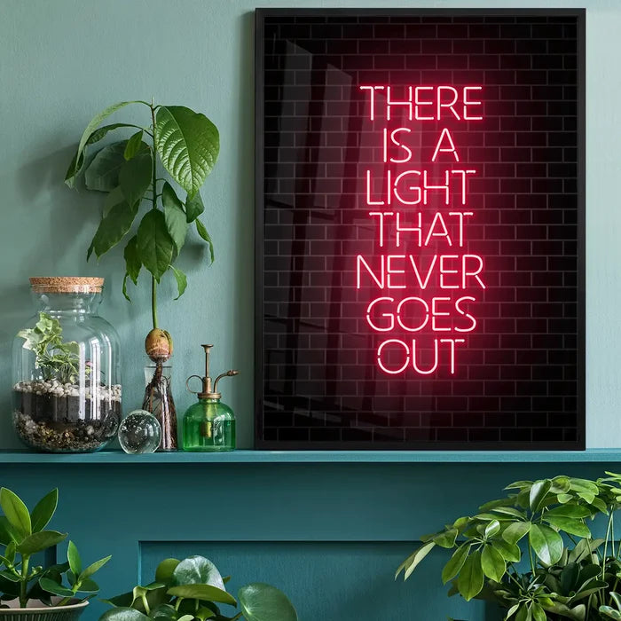 Black framed art print with "THERE IS A LIGHT THAT NEVER GOES OUT" in red neon-style text on a brick background.