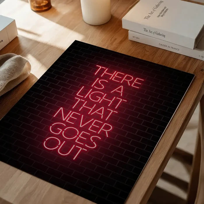 Red neon-style "THERE IS A LIGHT THAT NEVER GOES OUT" lyric print on a black brick background.