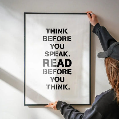 Black framed "Think Before You Speak. Read Before You Think." typographic print on white archival paper.